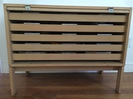 The front cover slides up and disappears inside on top of drawers, exposing 5 sleek pull our drawers. This is the ultimate jewelry cabinet!