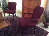 Burgundy arm chairs, Asian themed area rug.
