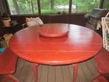 Round wood patio table with four benches and built-in lazy susan