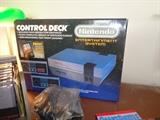 Complete Nintendo (NES) game system with controllers, gun, joy stick, games and original box