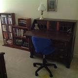 secretary desk, modern office chair and some bookcases 