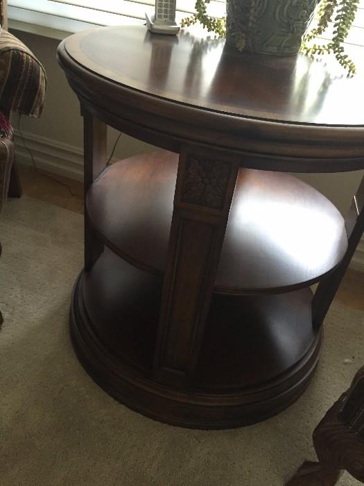Ethan Allen townhouse library table. 28" diameter. alder  frame, cherry veneer. one fixed shelf and four posts.  carved floral rosette on each post.Paid $750 asking $450