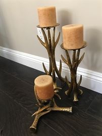 three gold tree like candle holders.  sold with candles.