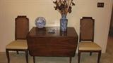 This stylish Danish Modern-style drop-leaf table has no discernable brand but is a nice and well-crafted piece.  Displayed here with the other two side chairs to the dining room set, the 12-inch leaf is not pictured, but it is available, making this a great table for display, as is shown here, or as a dining room table, with drop leaves extended, as well.  The clean lines would look great in a home with modern decor or in an eclectically-decorated home with furniture from many periods and styles.