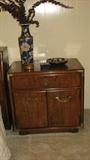 The nightstand doesn't lean.  It's the fault of the photographer.  However, this is a closer photo of the style and detail of the bedroom suit.