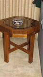 The octagonal teak end table matches the wood and style of the rest of the bedroom suit or could be a stand-alone piece.  It has an octagonal glass inset in the table top.