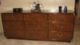 The teak 9-drawer mirrorless dresser matches the rest of the Asian-inspired bedroom suit described earlier and is, as the rest of the set, a part of a Drexel suit, so the quality of the pieces are high in this solid-wood set.