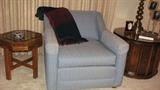 The light blue-upholstered low-back chair has clean lines, casters for easy movement, and is in remarkable shape.