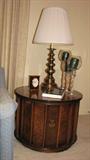 The photo doesn't do the beautiful burl in this dark-stained drum table justice.  The brass handle opens the table's door to a remarkable amount of storage in this end table.