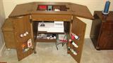Here is a Singer 9410 sewing machine in its cabinet.  I probably should have waited until Dad and the boys got the sewing machine up to the top of this cabinet, but I wanted you to be able to see that it is a good medium-shade finish, has opportunity for a lot of storage for spools of thread, bobbins, and other sewing equipment, and when configured properly has table space for the fabric while sewing.  It also is on casters, so it can be easily moved into the perfect space in your home.