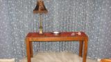 The credenza/sofa table in the bay window is solid wood oak and would look great with both modern style decor, antiques, or eclectic styles of furnishings.