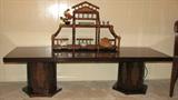 This low coffee table appears to be dark-stained teak but sports beautiful burl accents and cane panels in the hexagonal pillars.  As is the case with many of the furnishings and decor in the home, the table has an Asian feel.  A charming bamboo and wicker eterger sits atop the handsome table.