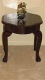 This photograph displays one of two 21 inch tall nightstand tables in dark cherry-look wood with Queen Anne style table top and legs with ball-and-claw feet.