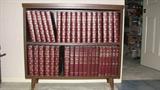 This dark-stained Mid-Century Modern-style book case currently houses a set of encyclopedias but could definitely hold whatever books you cherish and could also display things on the top, as well.