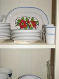 One of the built-in cabinets in the dining room holds a nice set of Poppy Trail pottery by Metlox.