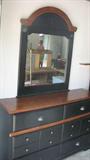 This handsome black mirrored chest of drawers would be a wonderful addition to your bedroom, with its clean lines, neutral color scheme, and smart post office-style hardware on the drawers. It has matching pieces as well.