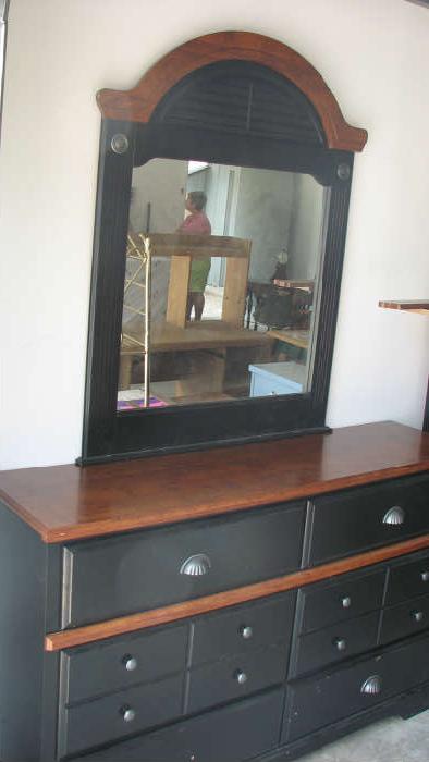 This handsome black mirrored chest of drawers would be a wonderful addition to your bedroom, with its clean lines, neutral color scheme, and smart post office-style hardware on the drawers.  It has matching pieces as well.