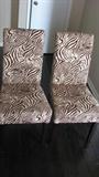 Parson's chairs never looked so exotic! The dark color of the legs and the black and white zebra would go with many different color schemes and ecclectic styles of decor.
