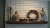 It's nice when you can just take a photo of a well-displayed group of items rather than having to merchandise them. There are two different styles of beautiful cream-colored vases, a tall candle stick holder, a vine wreath, and a really interesting display for a profusion of votive candles.