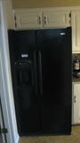 The black Maytag refrigerator has in-door water and ice functions.
