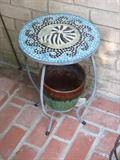 This patio table has a beautiful mosaic top with a slightly naitical feel.