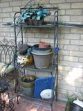 This iron patio shelf can hold pretty things from plants to pieces of pottery.