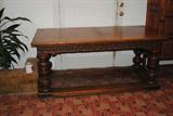 If you need a good solid refectory table , this is it.  It is in oak, is heavely carved and has massive turned bulbous legs.  It is approximately67x31x30 and is Englishc. 1910-1925.