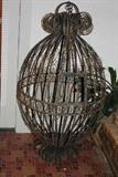 All you need is a big parrot to go in this bird cage.  The cage measures about 50" tall and 27" at its widest part.  It is iron and has just the right amount of rust to give it the right patina.