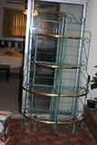 There are two of these iron and brass corner shelves.  They are about 6' high and 29" at their widest part.  They are nice enough to go in the house and solid enough to use on the patio.