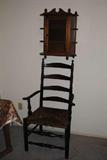 This is a rush seat, ladder back chair.  Some of the rush is broken but it is usable "as is" or I will loan you a book on doing rush seats.  The hanging curio above the chair will just fit that place in your home.