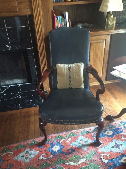 One of two leather, open arm side chairs