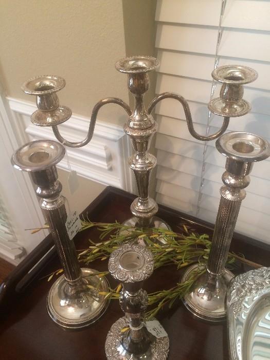 Some of the many silver plate candle holders