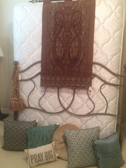 Iron headboard; decorative pillows & tapestry