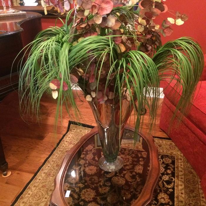 Floral arrangement on antique oval glass top table