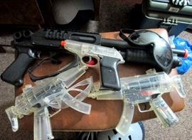 Seem to be paint ball guns with protective eye gear and helmets