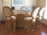 Gorgeous contemporary wood home bar with raised glass top and 4 matching bar stools. Has a locked liquor cabinet