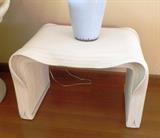 Lovely sculpted rattan side table is a conversation piece!