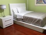 Queen size platform bed with matching nightstand. Metal lamp
