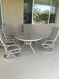 Round glass top table with 4 rocker chairs