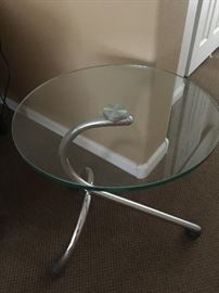 Contemporary glass round table on rollers
