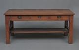 Gustav Stickley Oak Library Table
With three drawers, the inside of the central drawer with red Stickley stamp. 30" high, 66" wide, 36" deep  Bid at www.fairfieldauction.com through Wed. July 20th