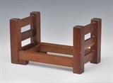 Gustav Stickley Oak Book Rack
Adjustable, the underside of one long end bearing the Stickley brand.  7" high, adjusting from 12" to 20 1/2" wide, 7" deep  Bid at www.fairfieldauction.com through Wed. July 20th