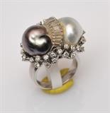Baroque Pearl 18k Gold Bi-Pass Ring
set with diamonds 6 1/2 ring size, 9.5 dwt gross.  Bid at www.fairfieldauction.com today through Wed. July 20th