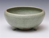 Chinese Celadon Planter
with three feet and incised concentric waves underglaze 12" diameter, 5" high.  Bid at www.fairfieldauction.com today through Wed. July 20th