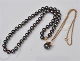 Black Tahitian Pearl and Diamond Pendant
on a 14" long 14k gold chain together with a black pearl necklace with a 14k and diamond clasp, pearls 8 1/2mm 18" long.  Bid at www.fairfieldauction.com today through Wed. July 20th