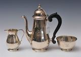Tiffany Sterling Silver 3-Piece Tea Set
Comprising coffee pot, cream pitcher and waste bowl, monogrammed JE, marked 22938 and 22604. Pot 8 1/4" high, pitcher 3 3/4" high, bowl 3 1/2" diameter. 29.1 troy ounces weighable..  Bid at www.fairfieldauction.com today through Wed. July 20th