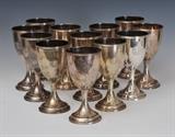 12 Schultz Sterling Silver Goblets
Each monogrammed DCC, pattern 20 Each 6 3/4" high 75.4 troy ounces.  Bid at www.fairfieldauction.com today through Wed. July 20th