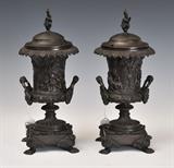 Pair of Classical Bronze Urn-form Argand Lamps
Unmarked, the covers with flame finials. 12 1/2 inches high overall.  Bid at www.fairfieldauction.com today through Wed. July 20th