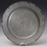 English Pewter Charger
Marked indistinctly underneath "MH" and "-BOX-" Ex Collection William Randolph Hearst, sold Hammer Galleries, 1941, lot 320. late 17th / early 18th century 18" diameter.  Bid at www.fairfieldauction.com today through Wed. July 20th