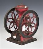 Landers Frary & Clark Coffee Grinder
painted cast iron, porcelain knobs, wooden handle and base. 14 1/2" high x 11 3/4" wide across handle, 10 1/2" deep.  Bid at www.fairfieldauction.com today through Wed. July 20th